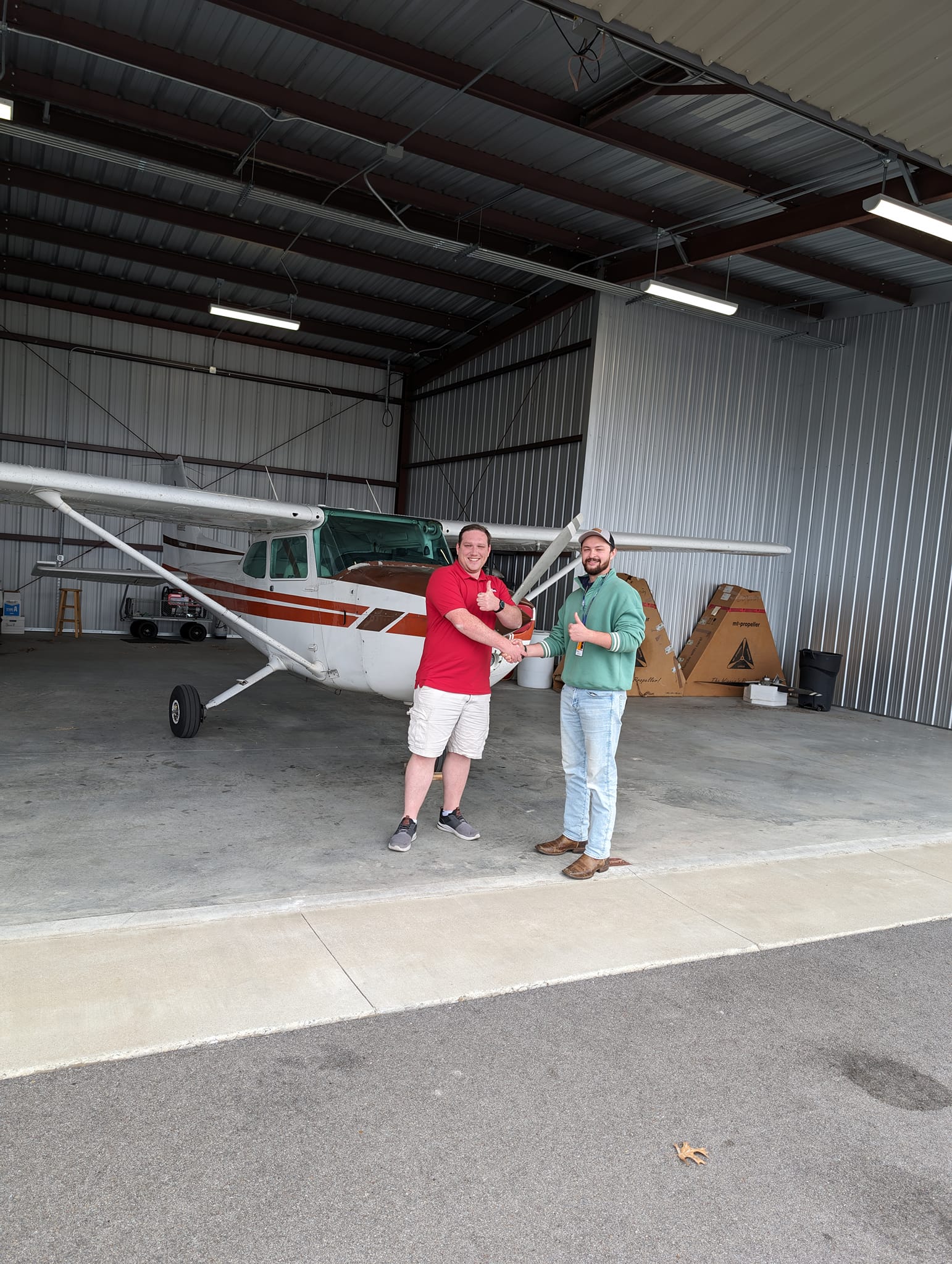 Brandon receiving his temporary certificate from his examiner